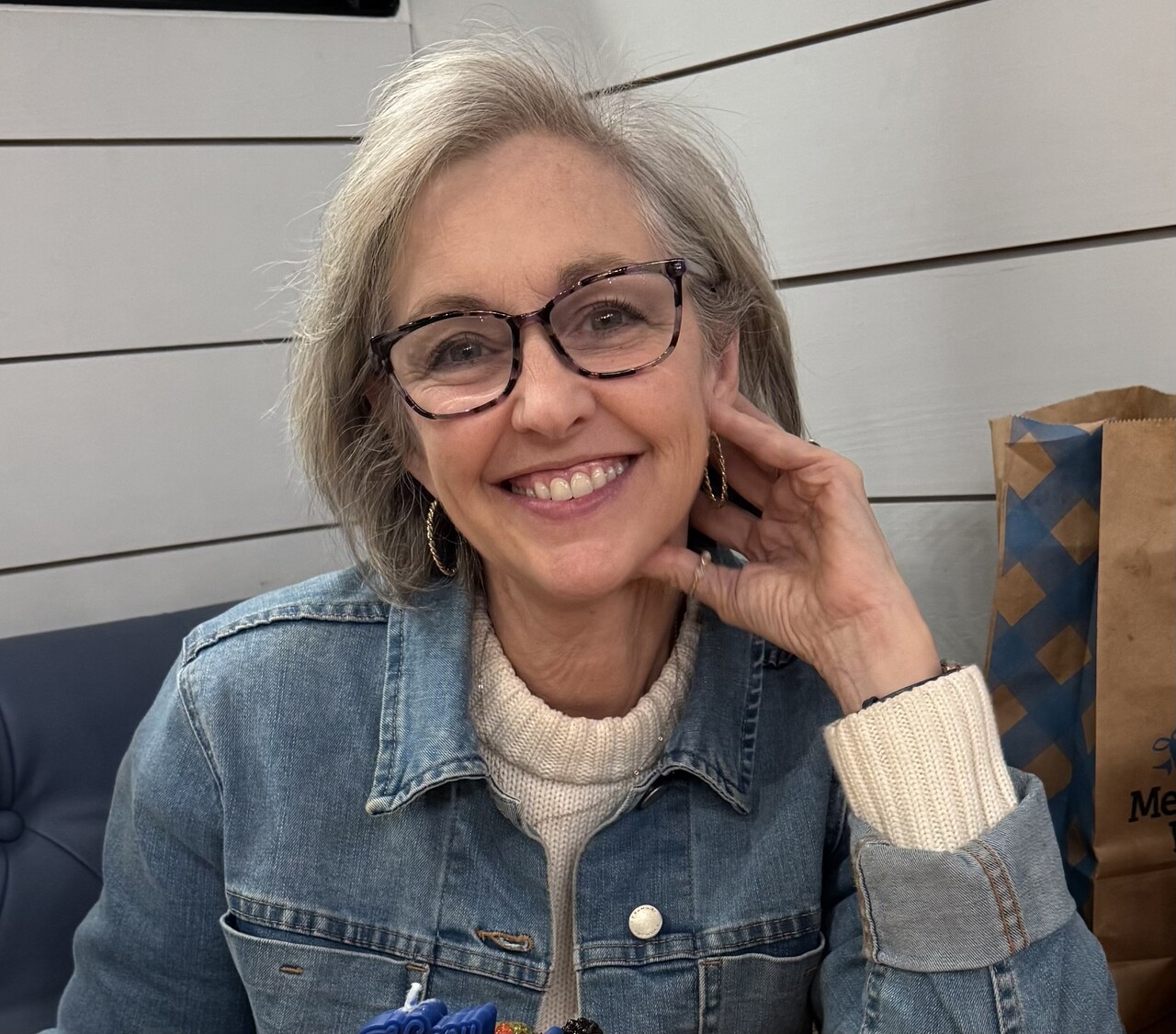 Gina Calvert, smiling, in a denim jacket